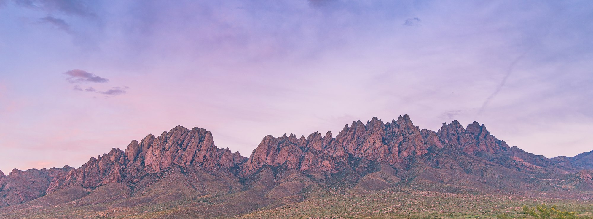The jagged peaks of the Organ Mountains at dusk above the desert near Las Cruces, New Mexico